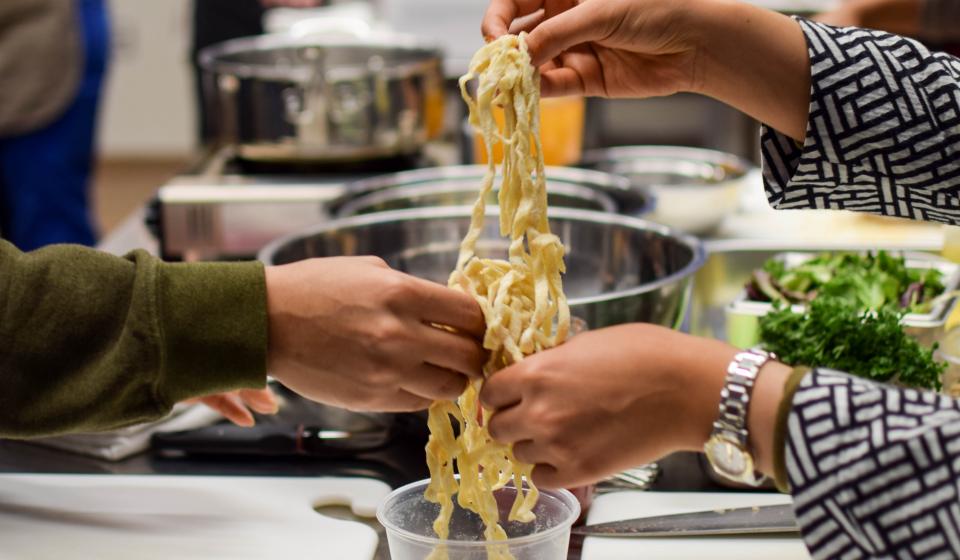 Hands holding fresh pasta